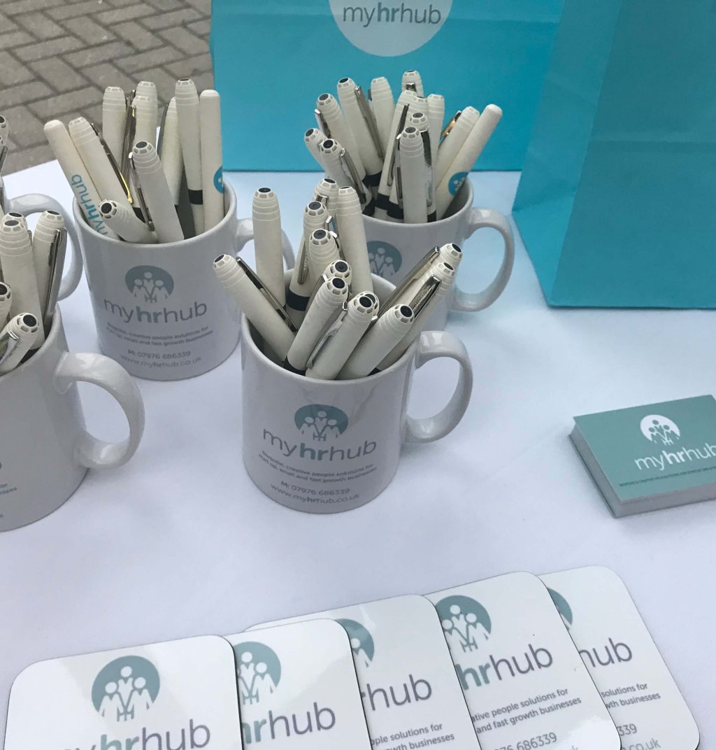 Stationary is laid out on a table at an HR consultancy event.