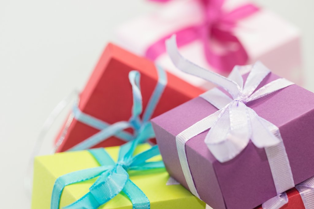 Multiple gift boxes are stacked on top of one another. They each have a bow.
