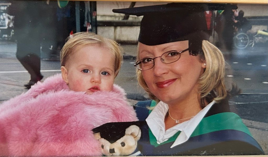 My HR Hub founder, Rebecca, at graduation, holding her daughter Tilly as a baby.